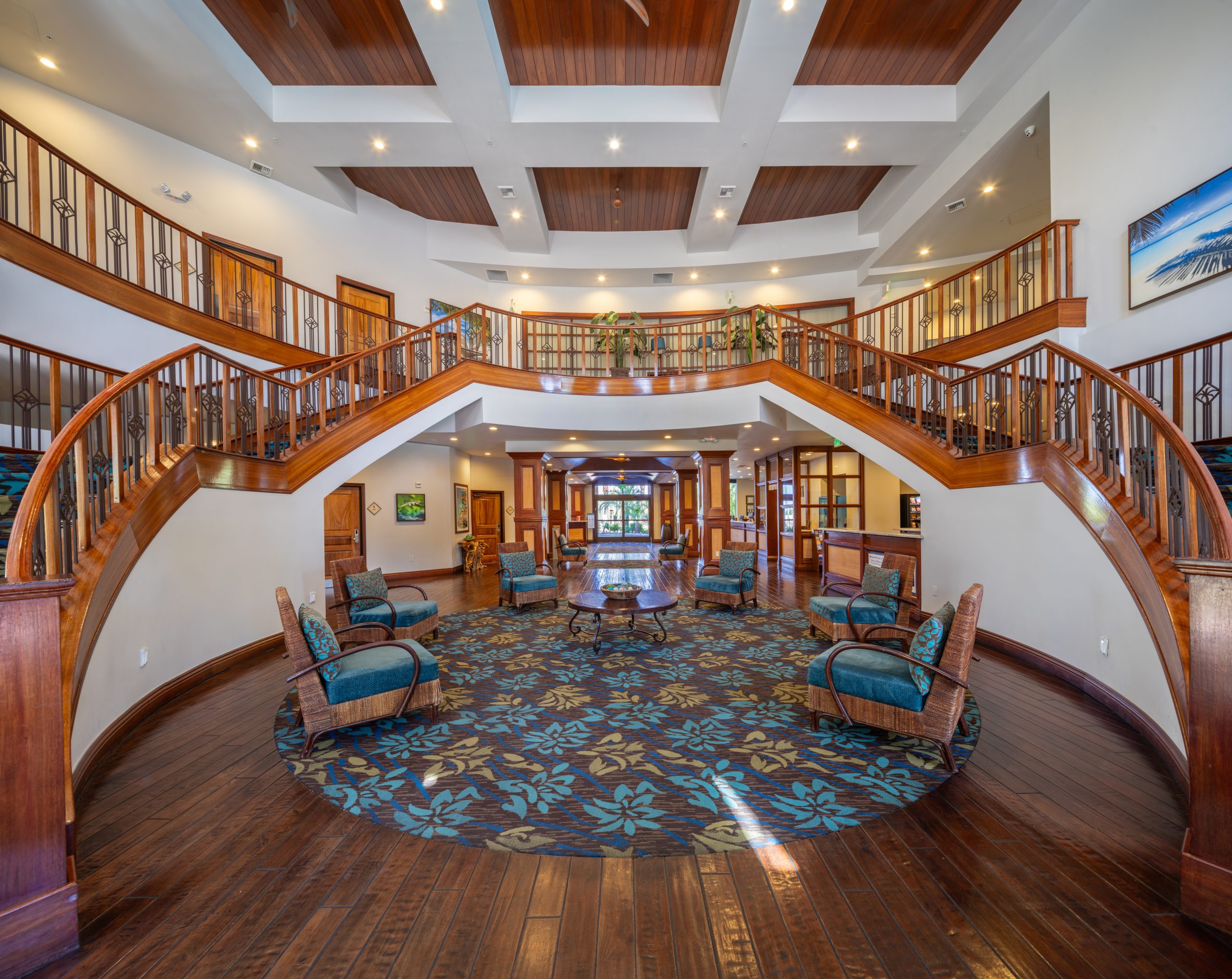 A large, open lobby with a staircase and seating area.